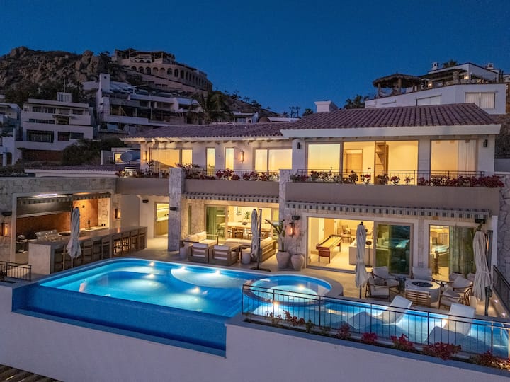 La Maraca villa exterior lit up at night with glowing pool